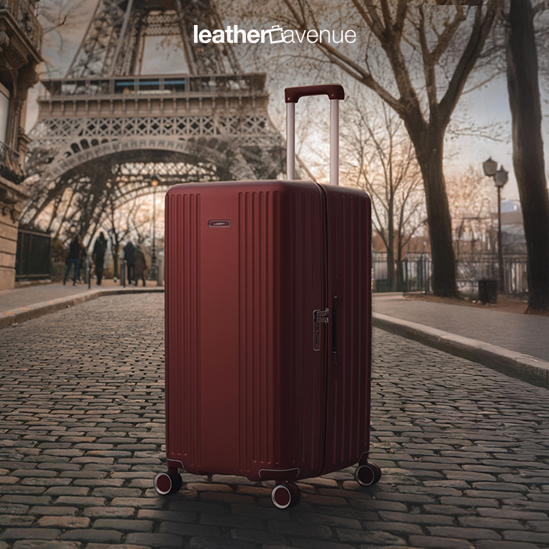 A sleek Lushberry Quantum luggage in a vibrant copper red, ready for holiday travel.