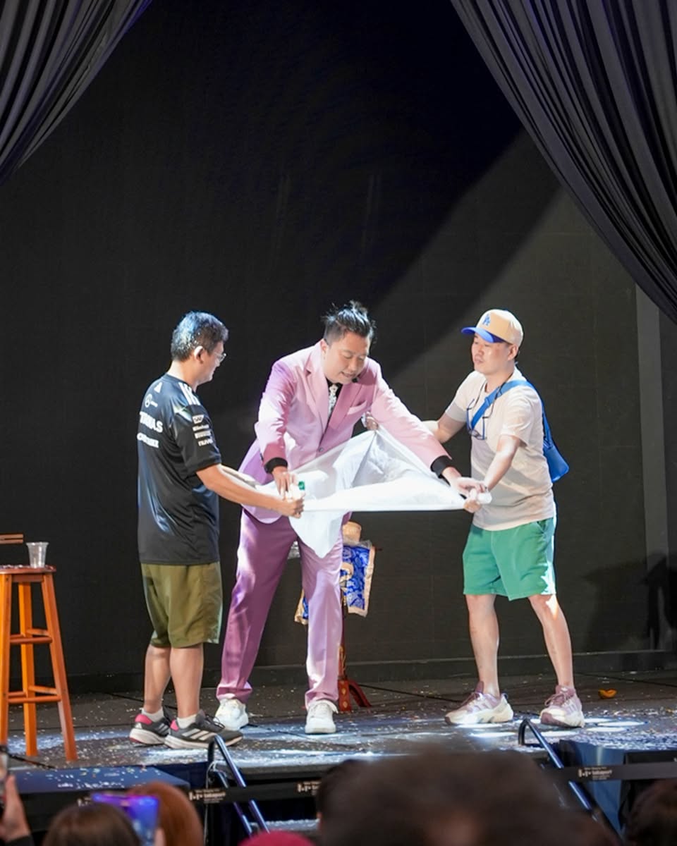 Families and children laughing and reacting to a magic show performance.