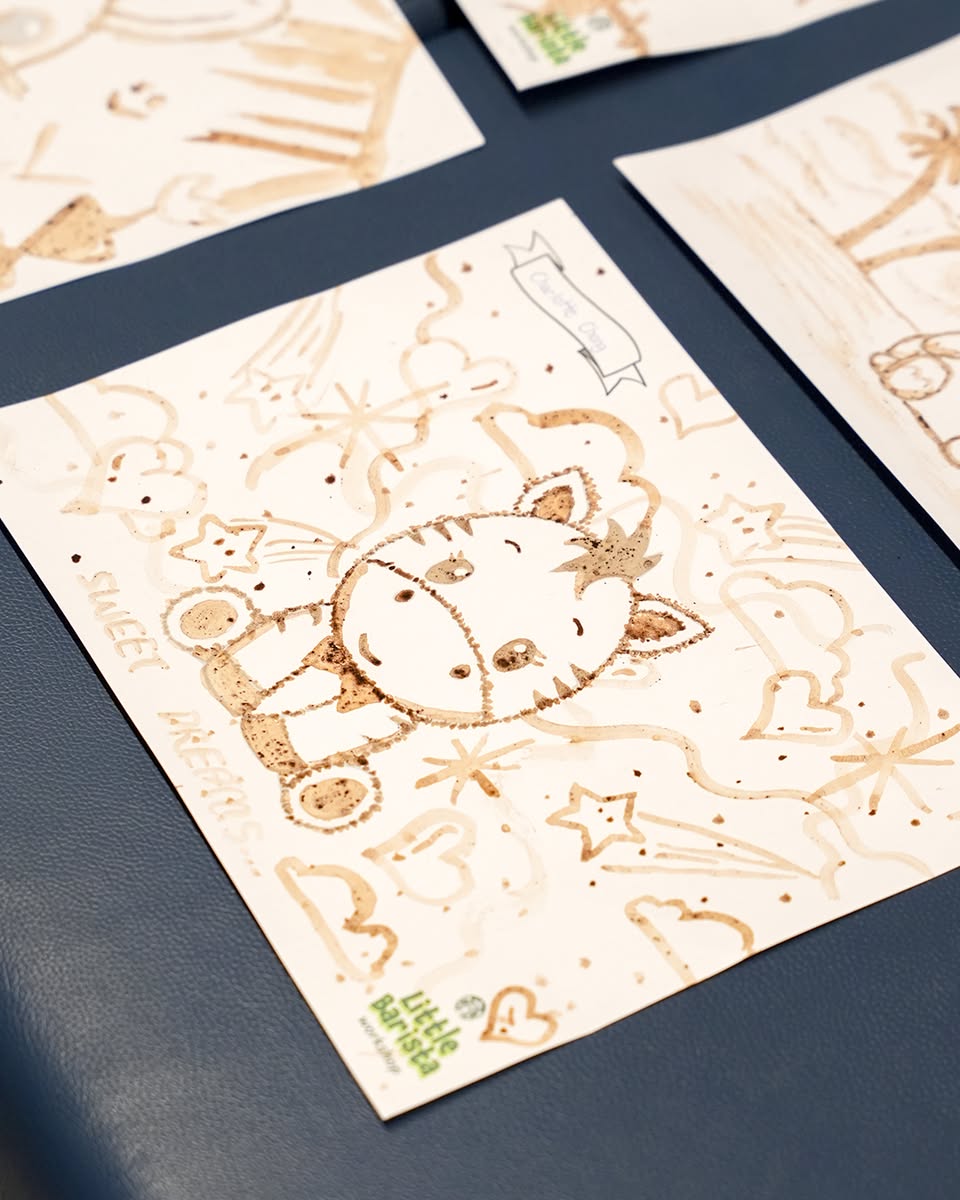 Kids focused on coffee painting during the workshop
