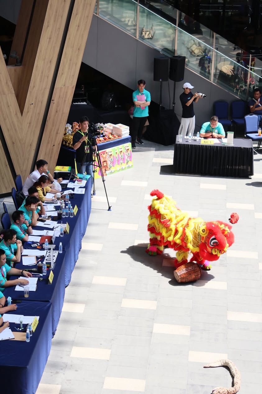 Acrobatic lion dance team performing high-stakes stunts