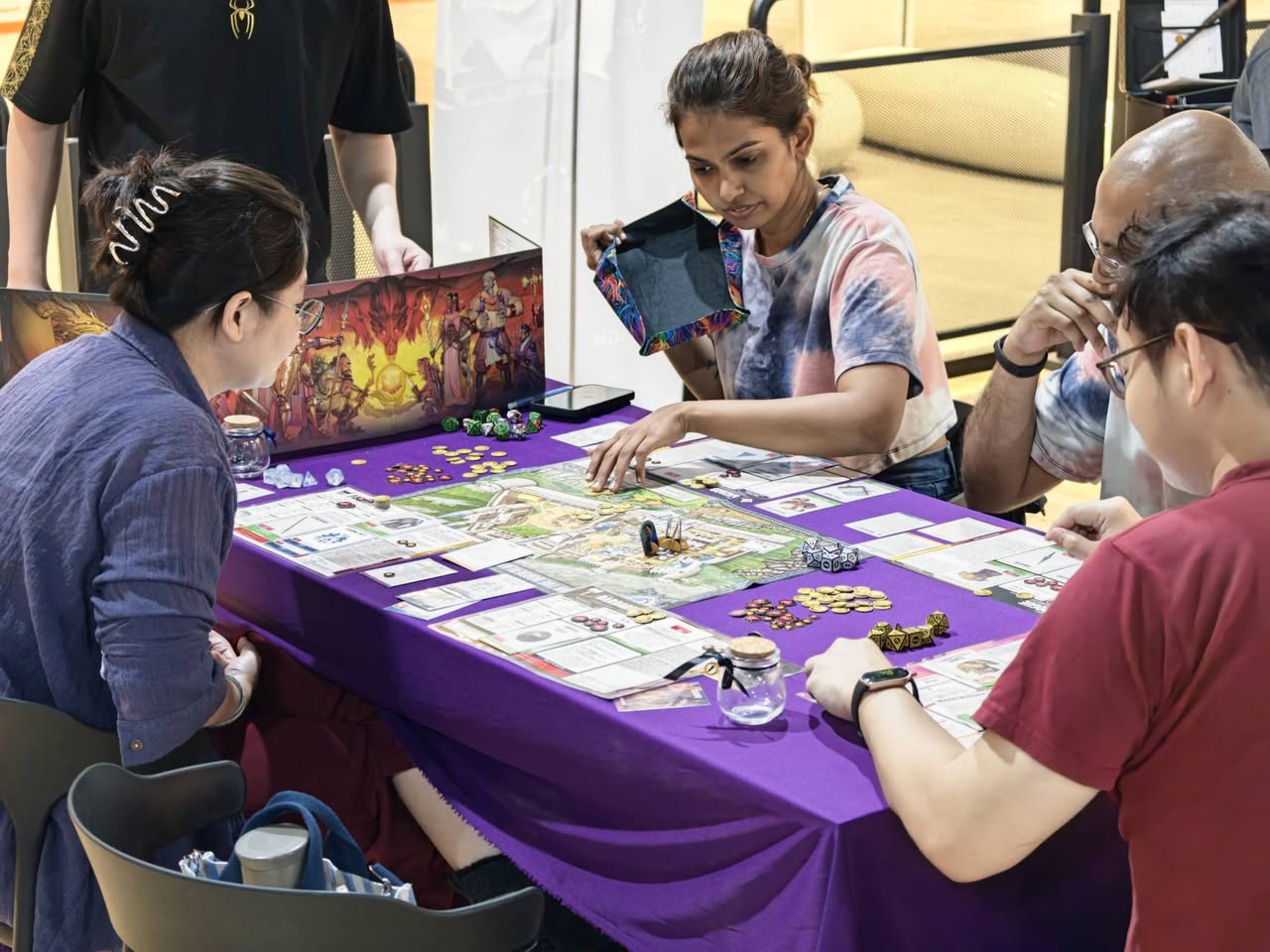People playing a tabletop board game at Spellbinder