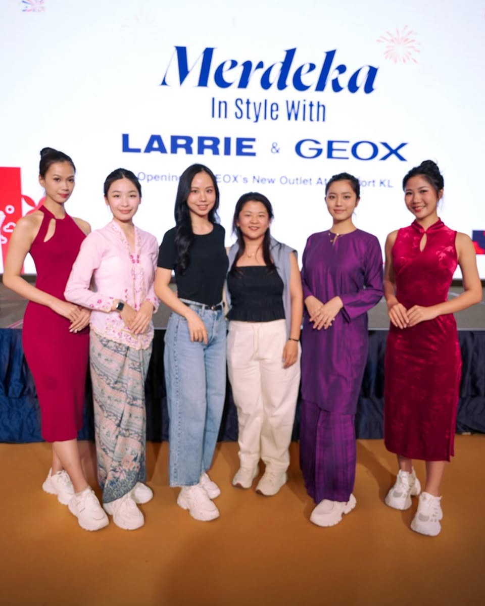 A lively scene from the Merdeka celebration with brand signage.
