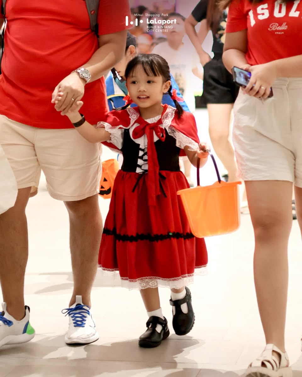 Family dressed in Halloween costumes enjoying an event