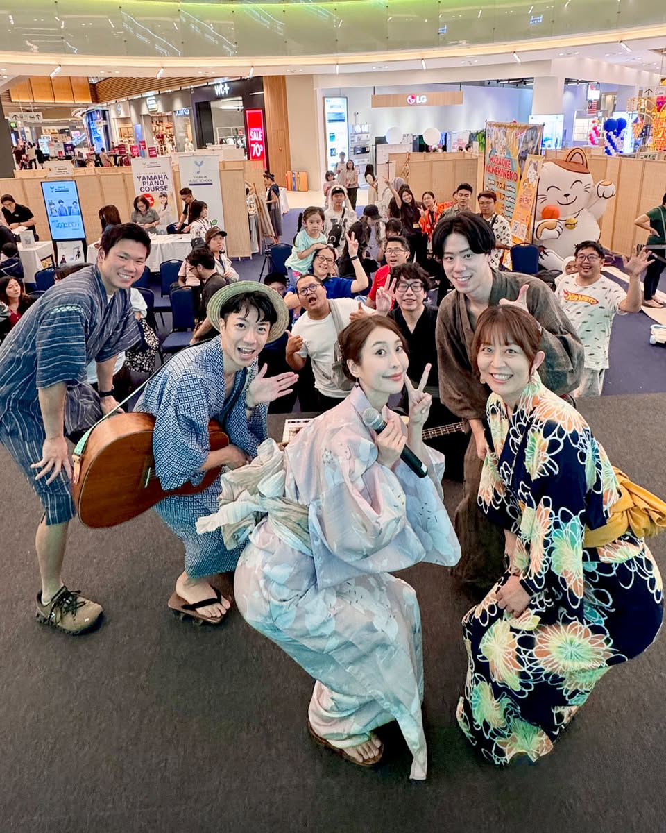 Enthusiastic festival-goers capturing memories at Kawaiimama Festival 2025