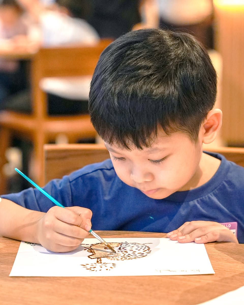 Children enjoying a storytelling session at the Little Barista Workshop
