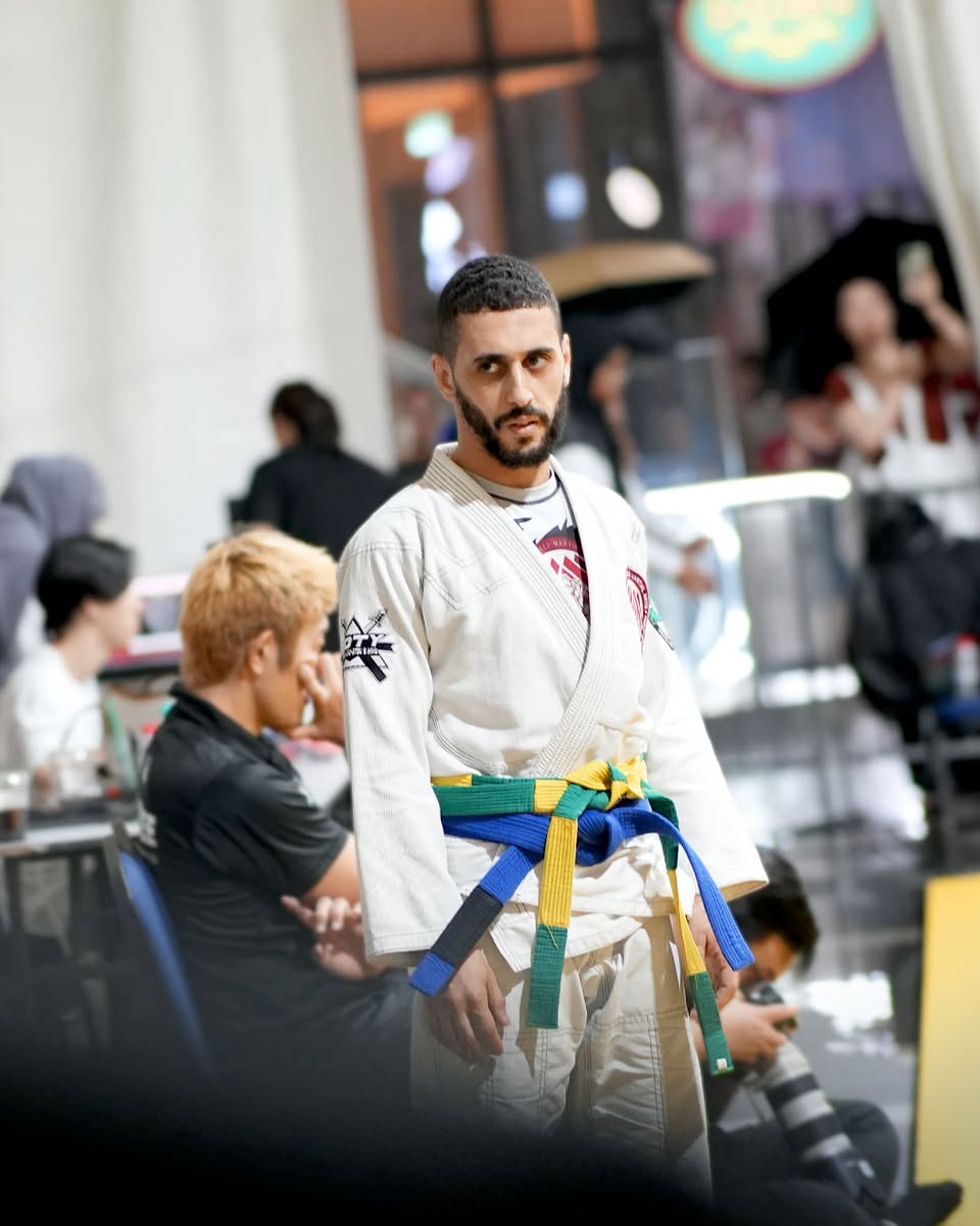 Audience gathered around the mats at the BJJ showcase