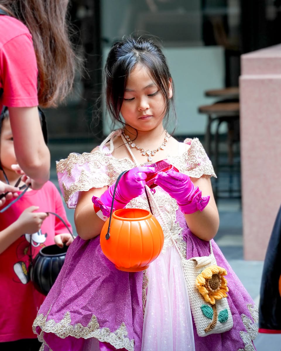 Delighted attendees showcasing their Halloween spirit at LaLaport BBCC.