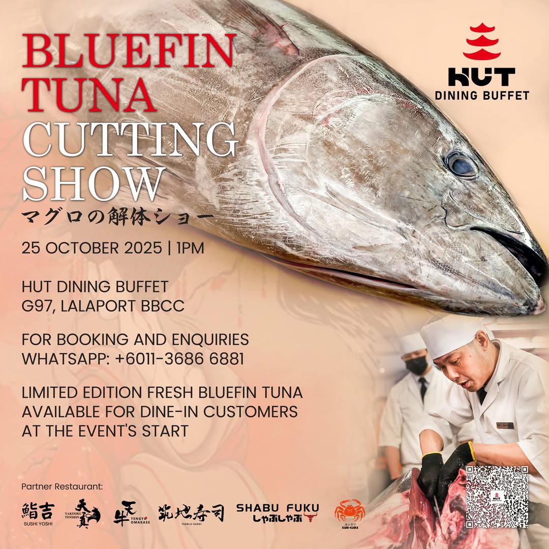 Master chefs expertly cutting a large bluefin tuna on a wooden block.