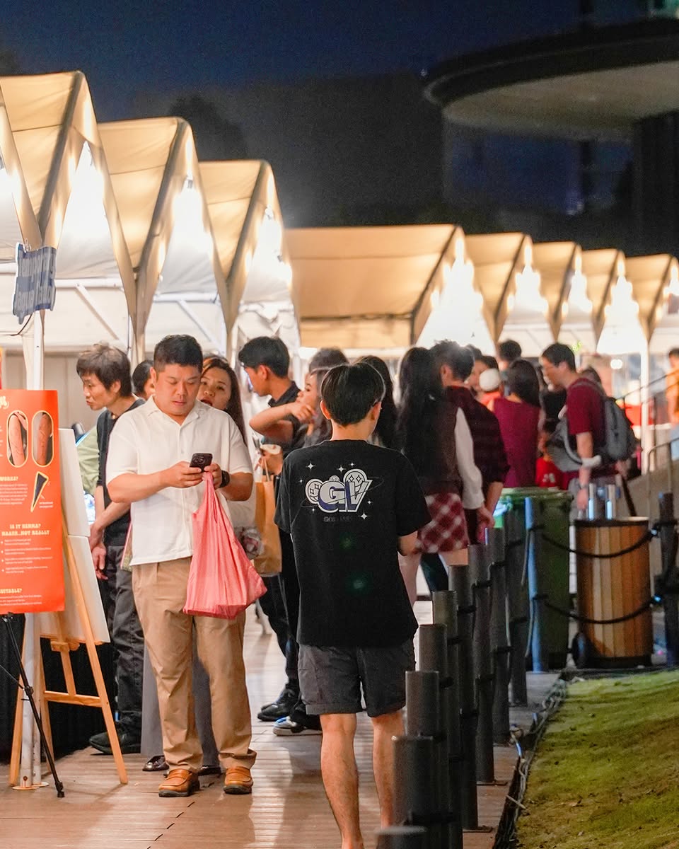 Snow falling on a festive rooftop gathering