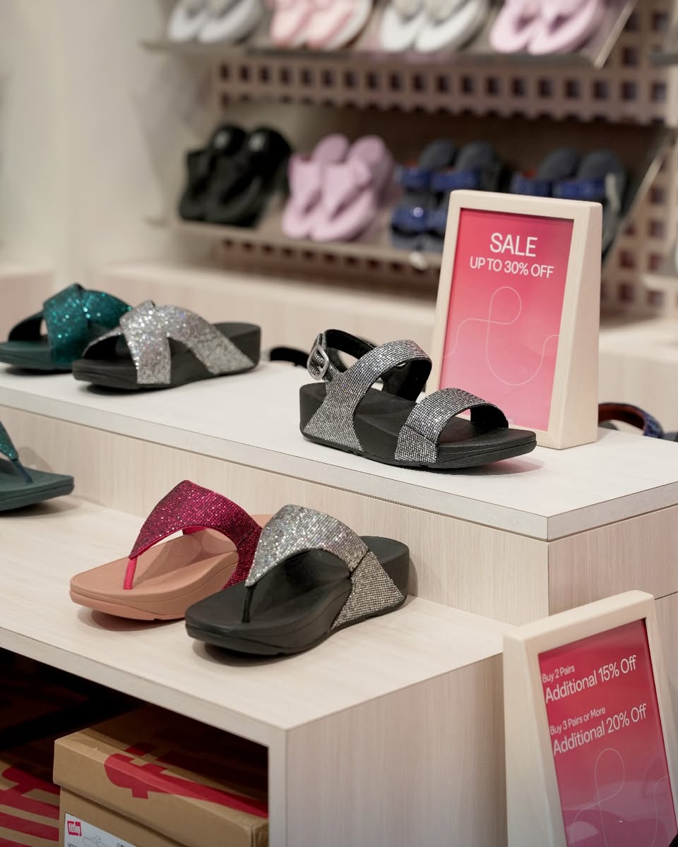 Person wearing FitFlop shoes, showcasing comfort.