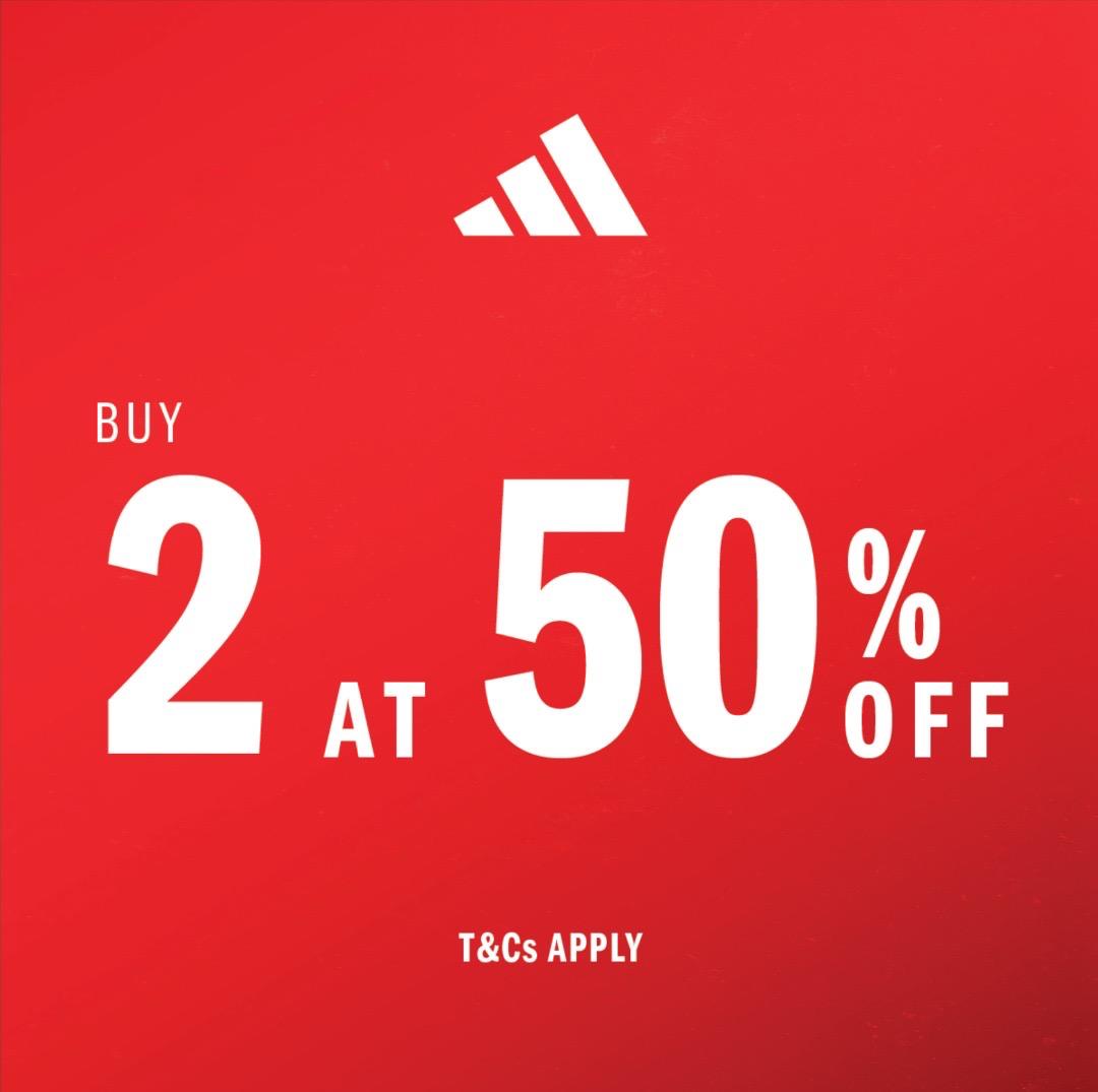 Adidas store exterior with promotional banner