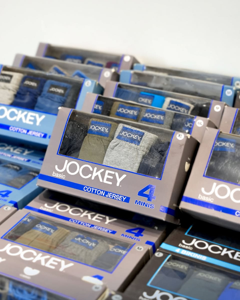 Jockey polo shirts and Moto Guzzi leather goods showcased in a modern setting.